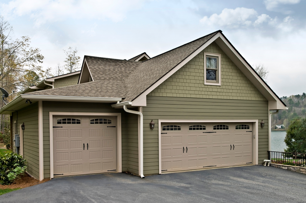 Green Garage with three bays and two stories.