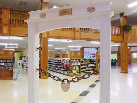White arch commemorating Keim Lumber's founding year as well as the year the new showroom opened.